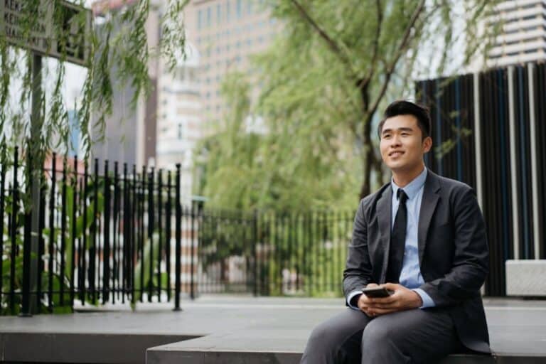 Young asian businessman thinking about investing in property